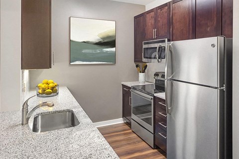 a kitchen with stainless steel appliances and granite counter tops
